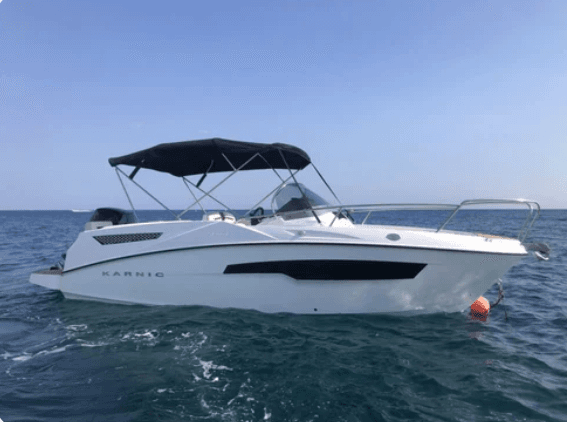 White motor yacht cruising on Lake Como with calm blue water