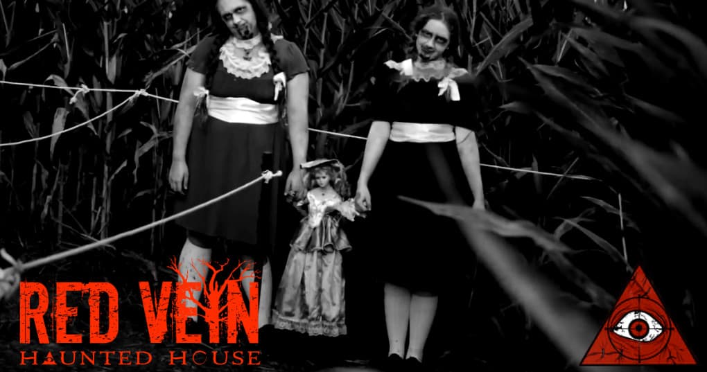 Actors in cornfield wearing vintage costumes on haunted trail