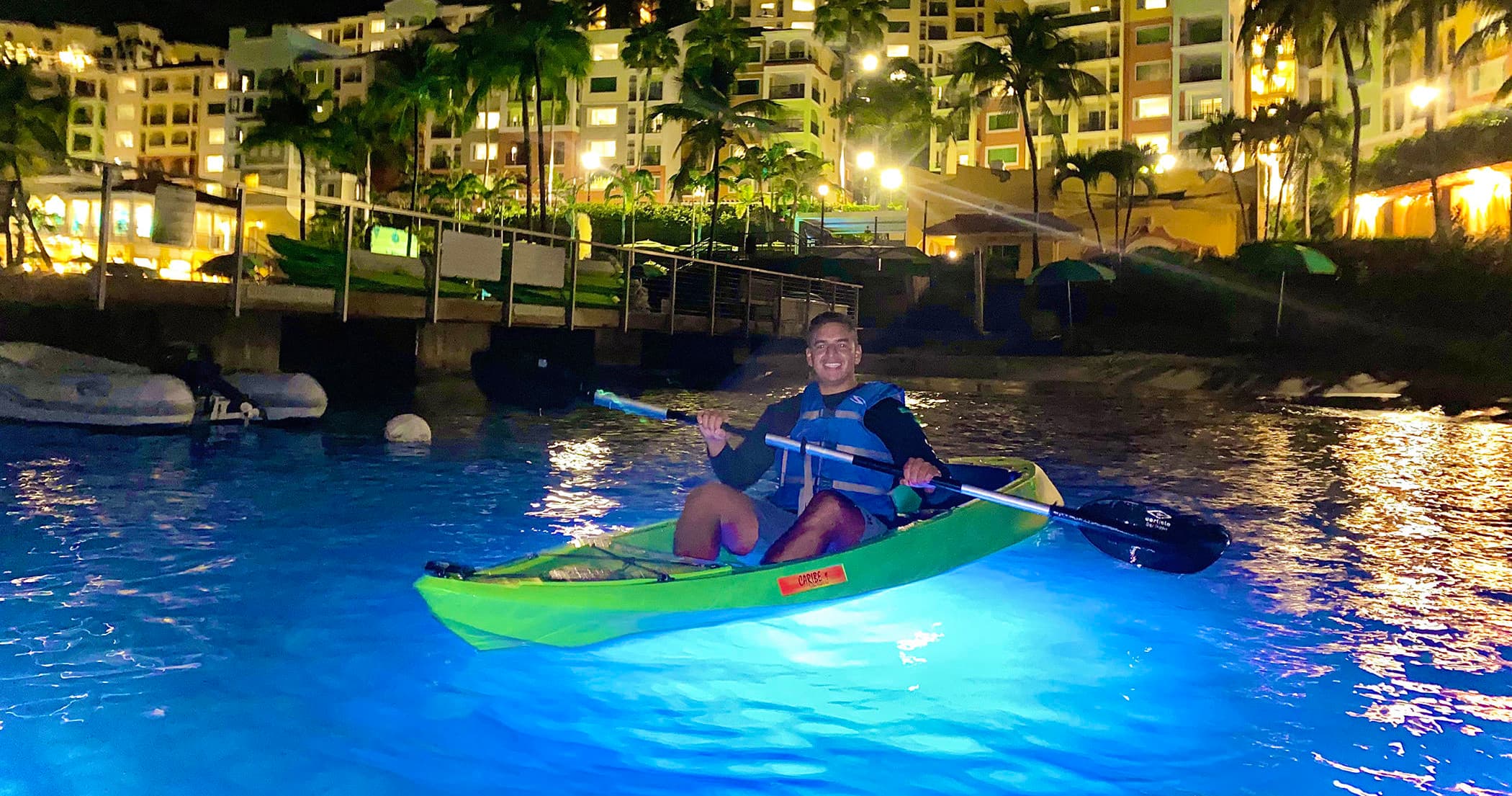 Night kayaking with illuminated water near resort shoreline, St. Thomas