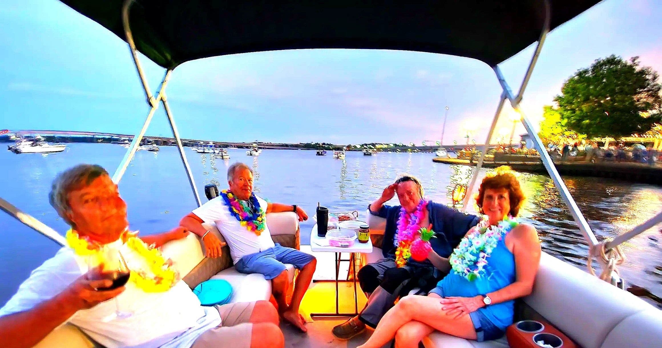 Friends enjoying sunset cocktail cruise on leisure yacht