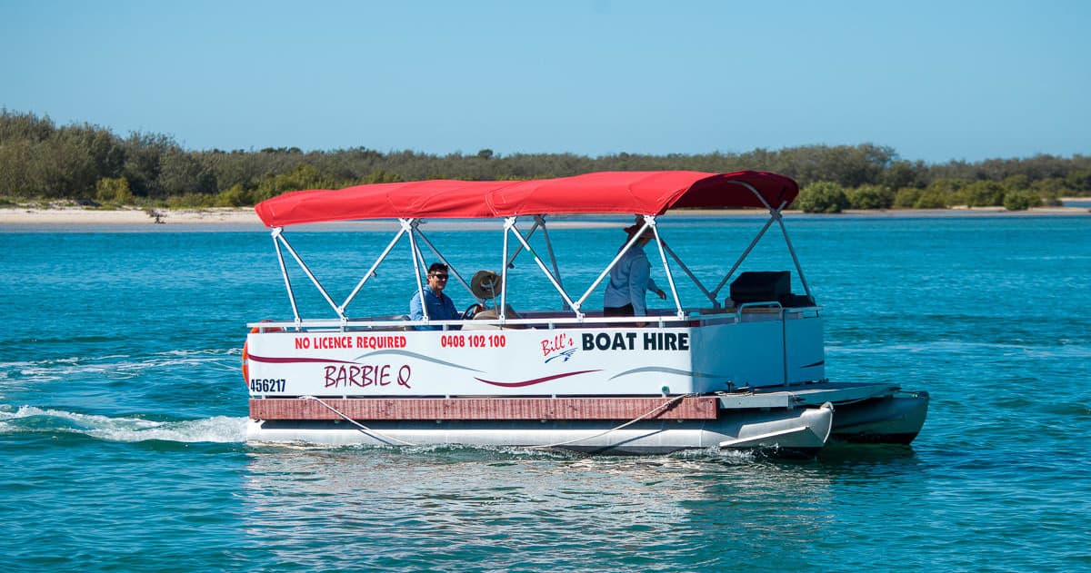 Boat hire pontoon with red roof offering coastal sightseeing