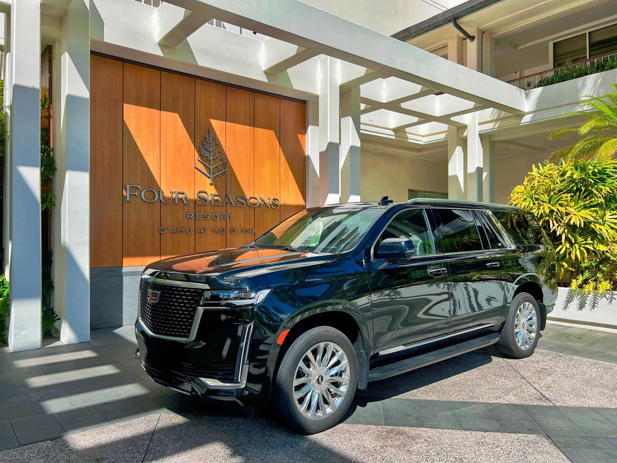 Black luxury SUV parked under hotel porte-cochere in Hawaii