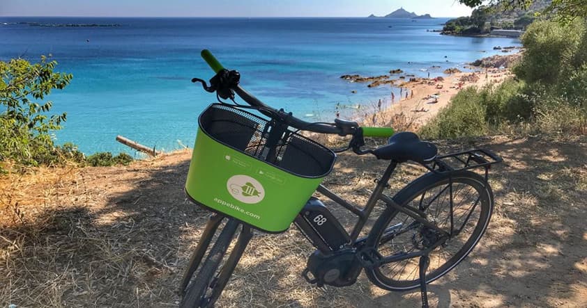Electric bike parked overlooking turquoise Mediterranean beach
