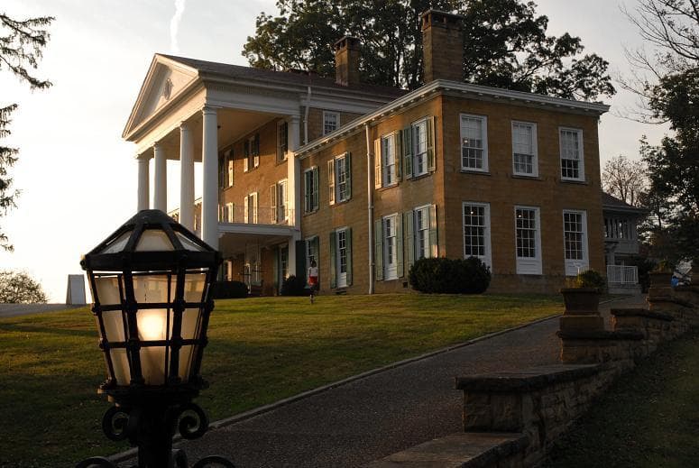 Historic estate mansion exterior at dusk for guided property tours