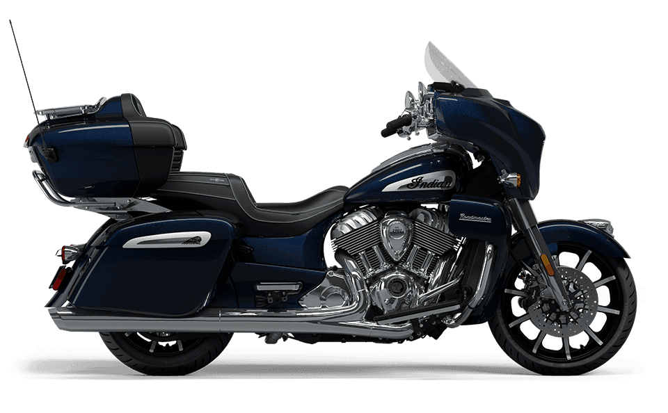 Blue Indian touring motorcycle, side profile on clean white studio backdrop
