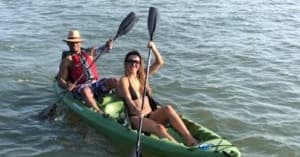 Two-person kayak paddling on choppy coastal waters