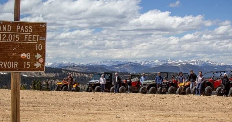 Scenic mountain panorama with off-road vehicle convoy, Colorado