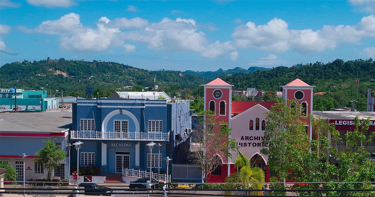 Coastal town waterfront with colorful buildings and hills