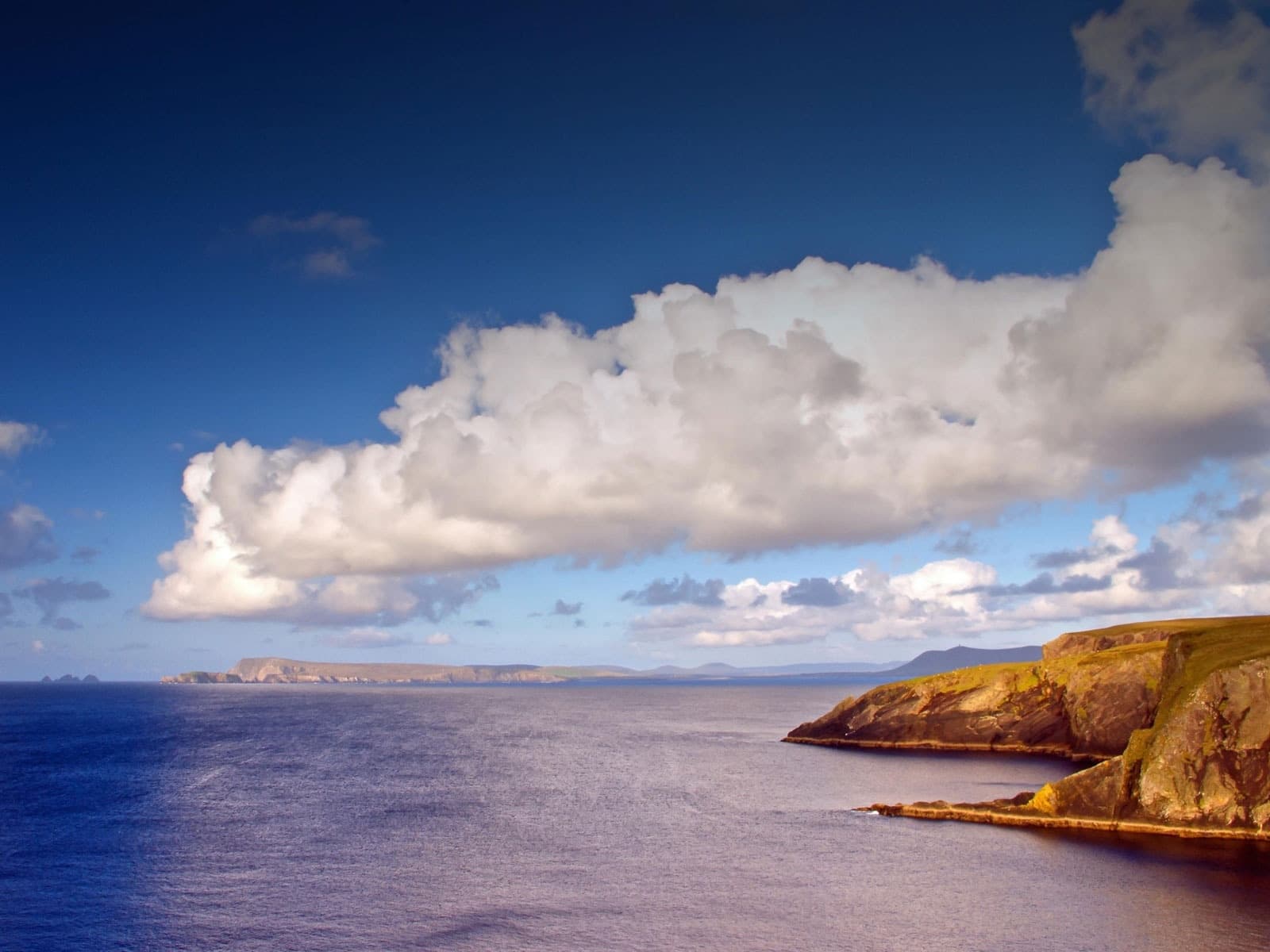 Scenic coastal cliffs and ocean viewpoint under dramatic clouds