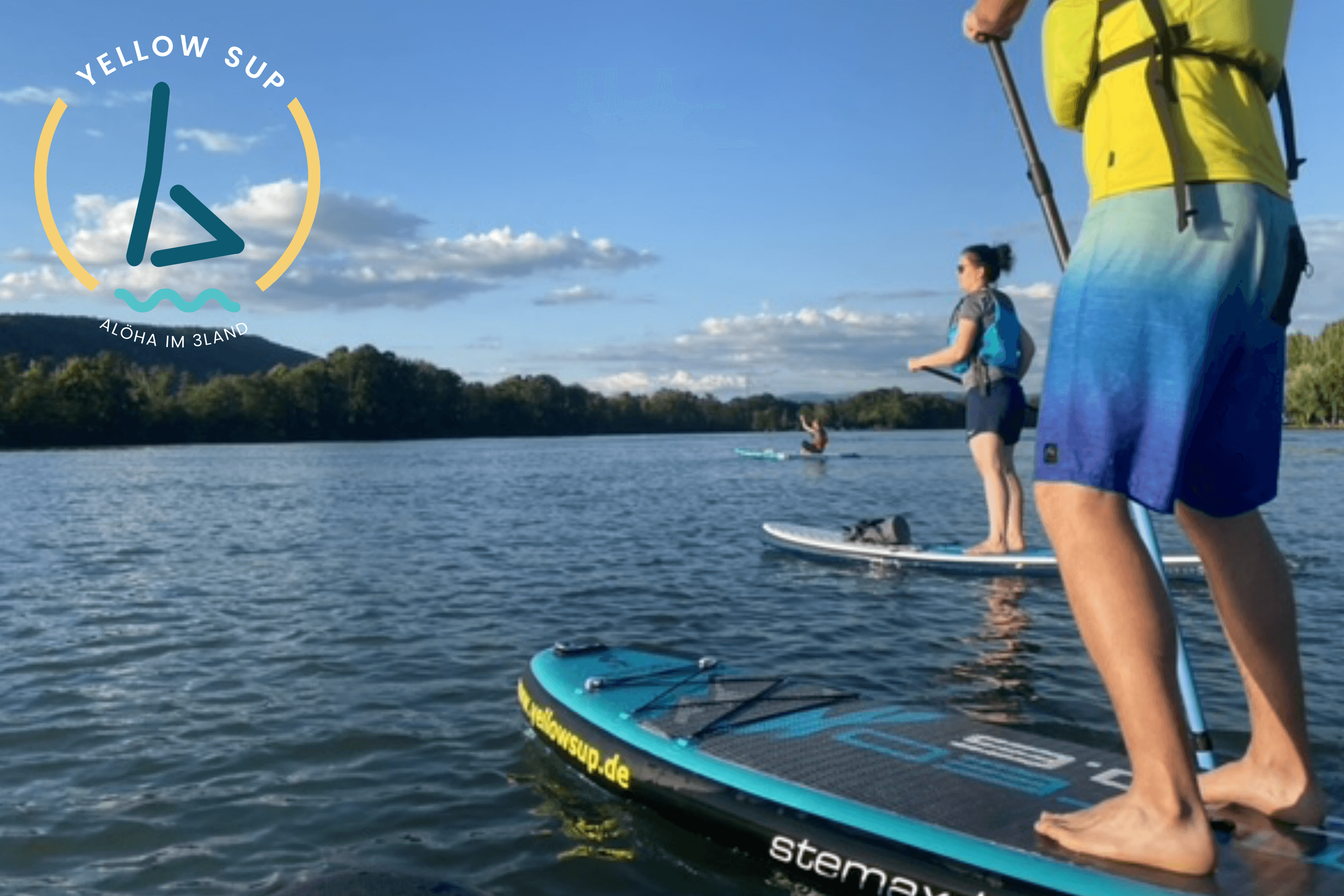 Close-up of paddleboarders' feet on SUP deck over calm lake