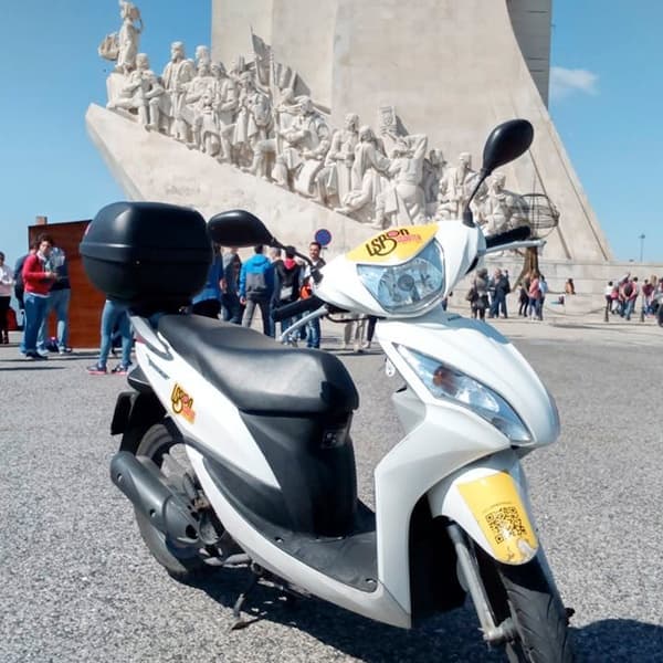 Scooter rental parked at Discoveries Monument waterfront, Lisbon
