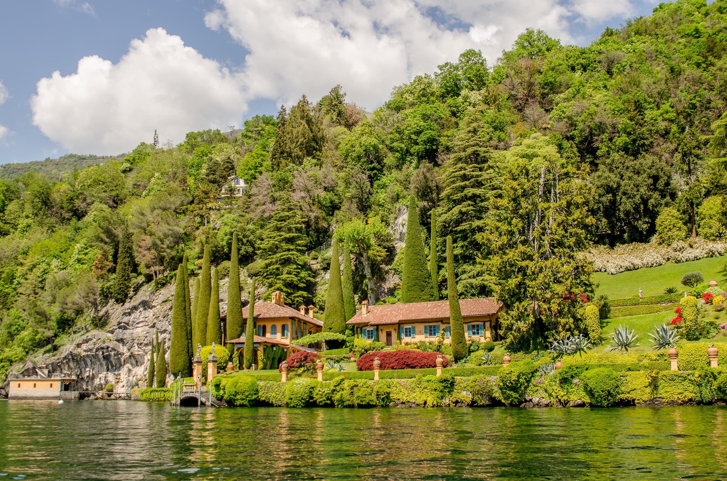 Scenic lakeside villa and cypress trees on Lake Como shore