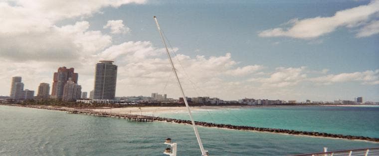 City skyline viewed from boat over blue coastal waters