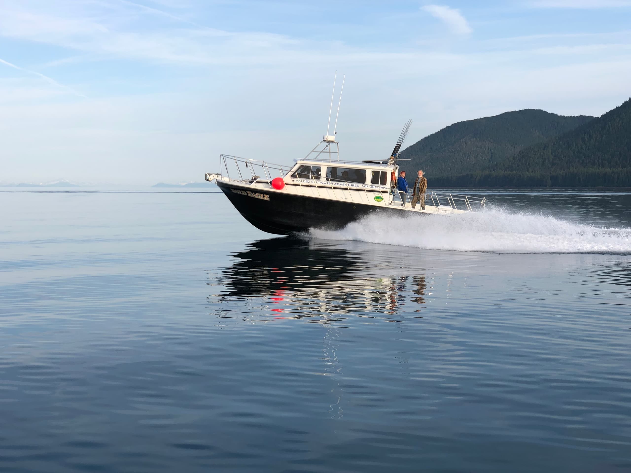 Charter fishing boat cruising calm waters near Valdez, Alaska
