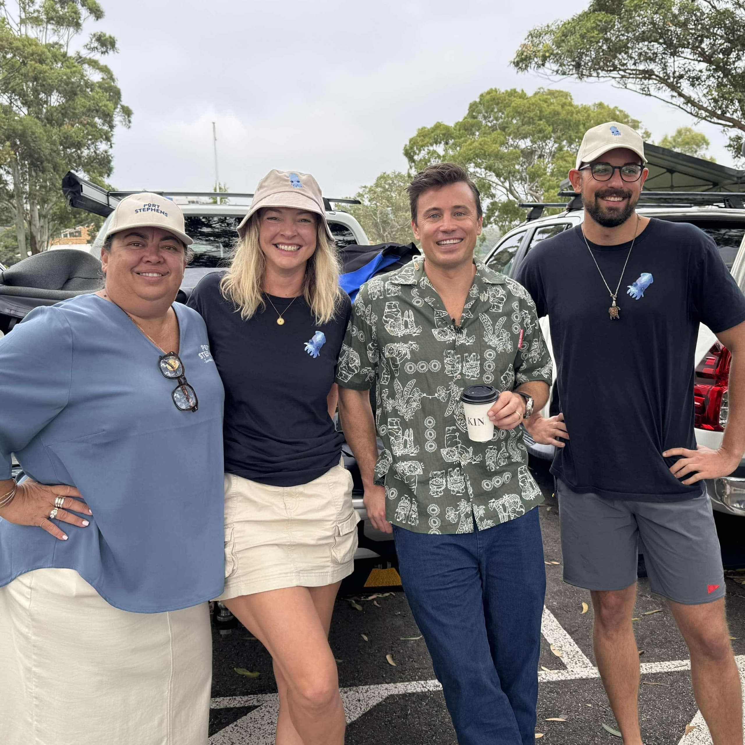 Smiling dive team posing at trailhead parking before trip