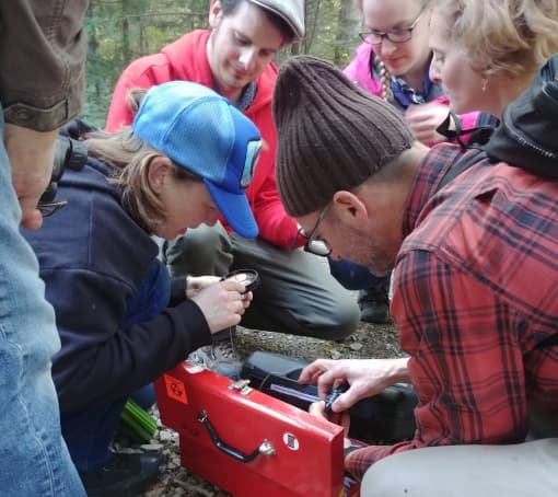 Outdoor group prepping gear for backcountry navigation workshop