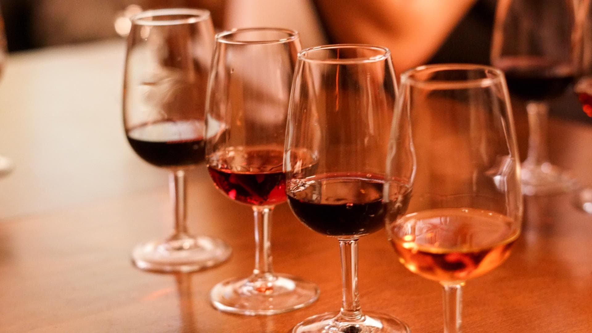 Selection of red and rosé wines in glasses on tasting table