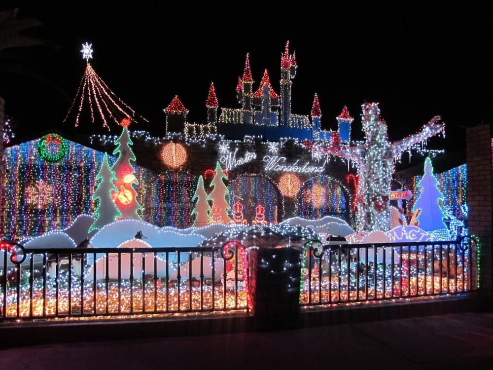 Colorful illuminated castle-style holiday light display at night