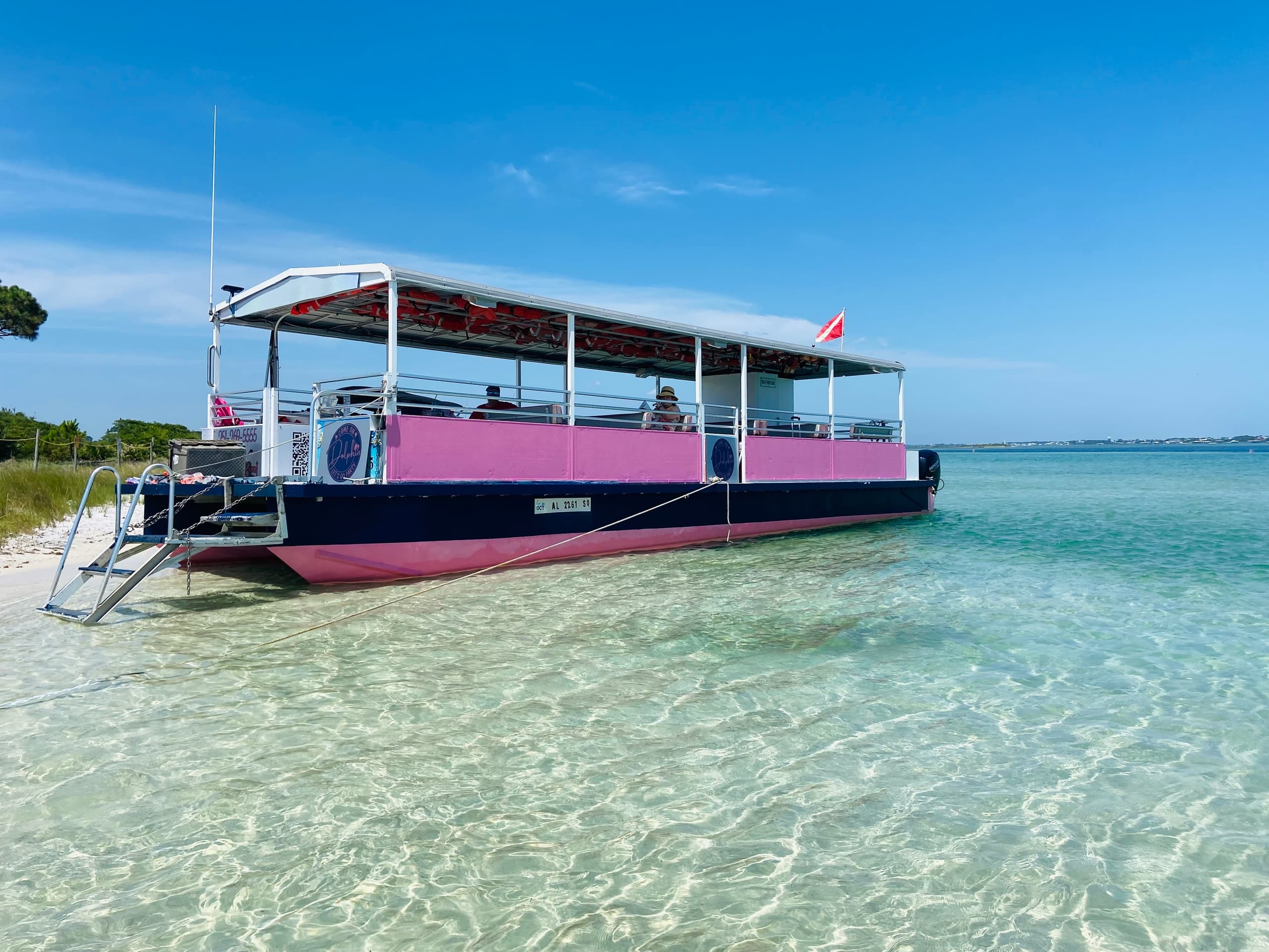 Shallow-water sightseeing boat anchored in clear Gulf waters