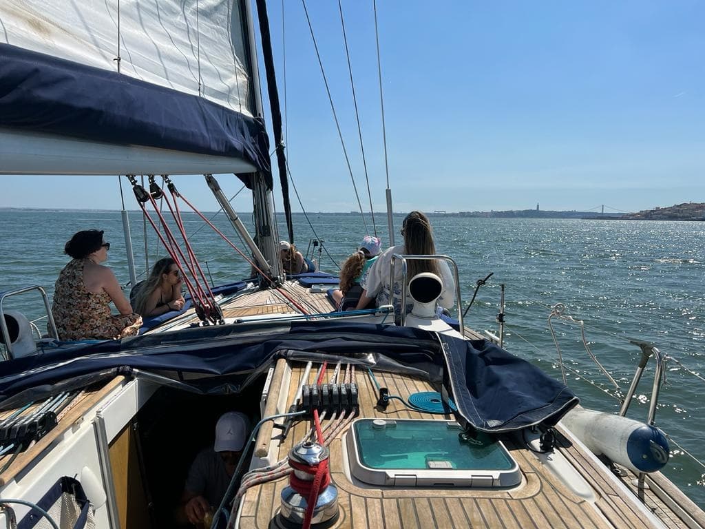 Sailboat deck view cruising open sea under clear blue sky