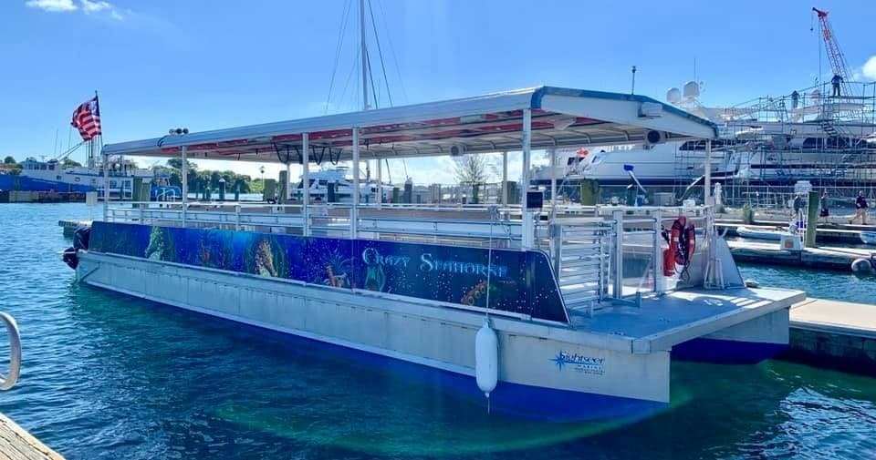 Shuttle boat docked at marina offering rides to Peanut Island