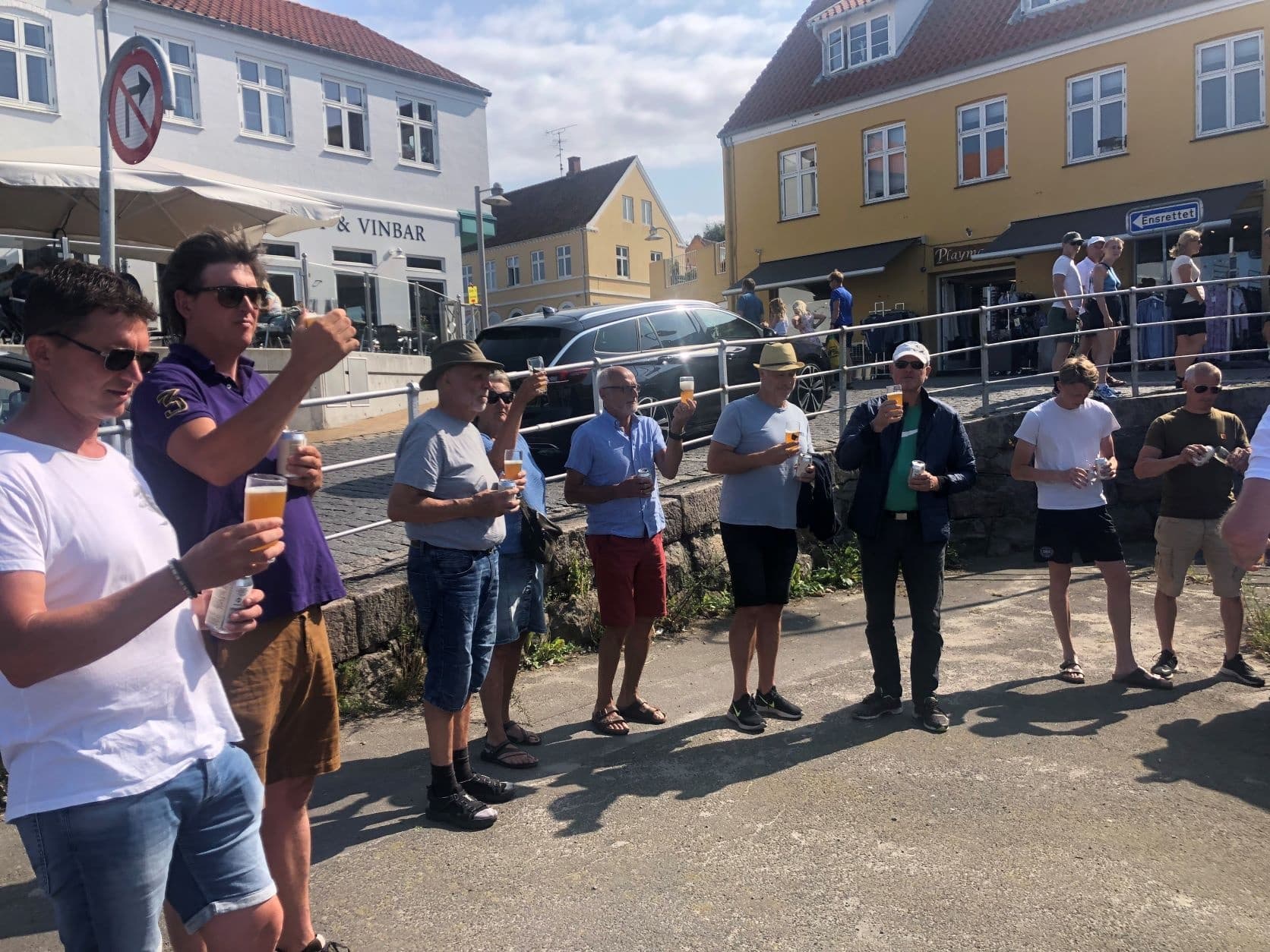 Group of participants toasting outdoors on sunny town street tour
