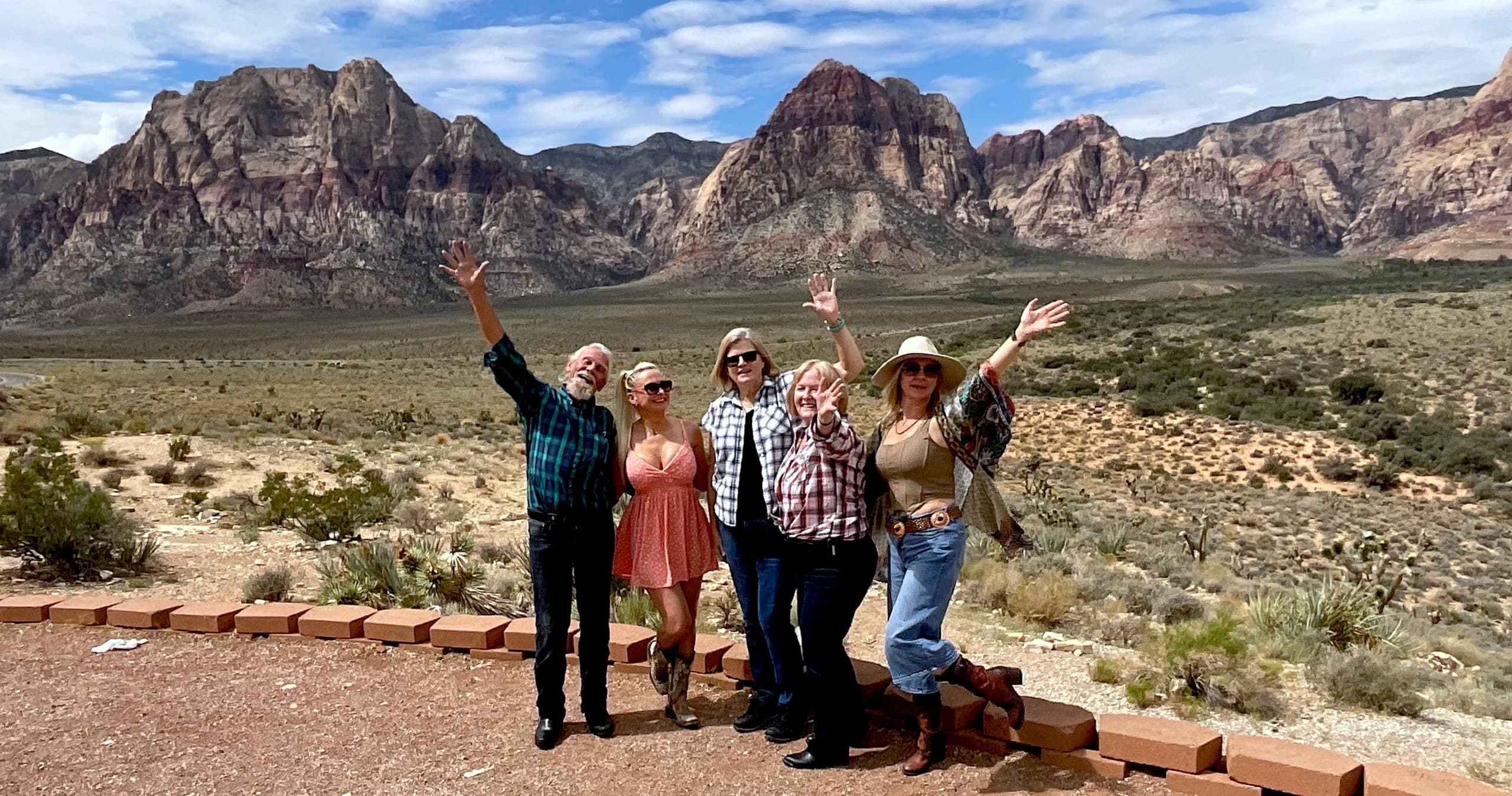 Hikers posing at Red Rock Canyon desert overlook, Nevada