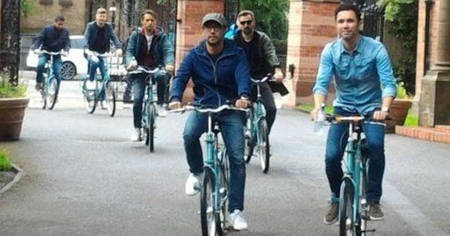 Cyclists riding through Glasgow streets on a guided bike tour