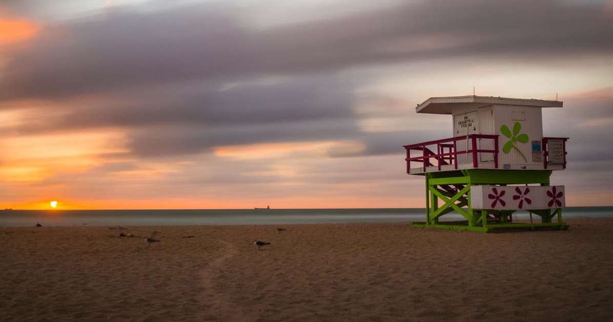 Sunset at Miami Beach lifeguard tower, tranquil shoreline view