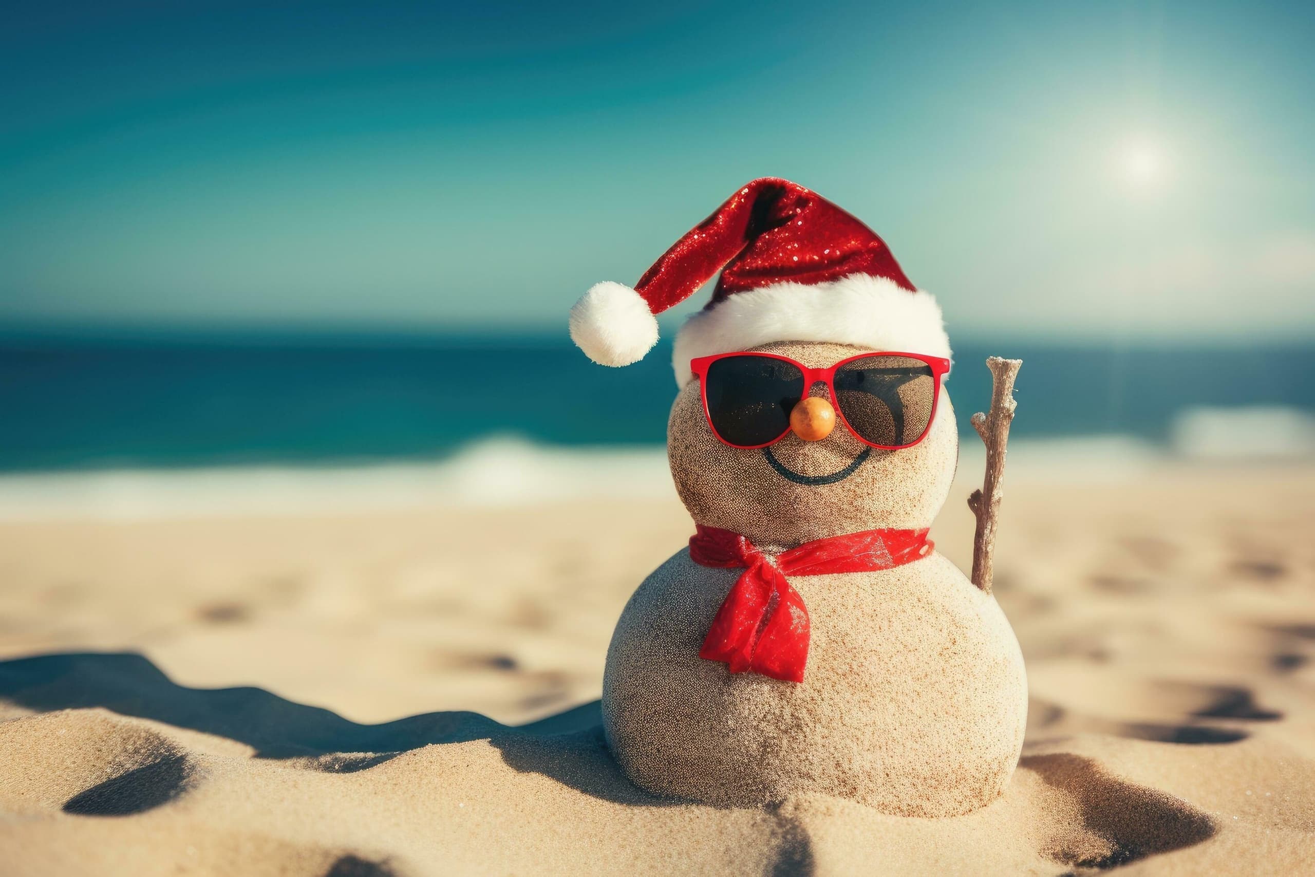 Beach snowman with Santa hat on sunny sandy shore holiday scene