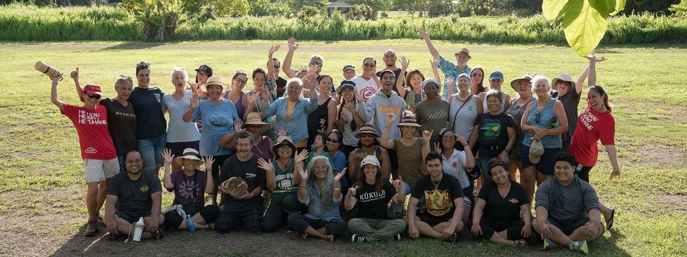 Outdoor group posing after team adventure on grassy field