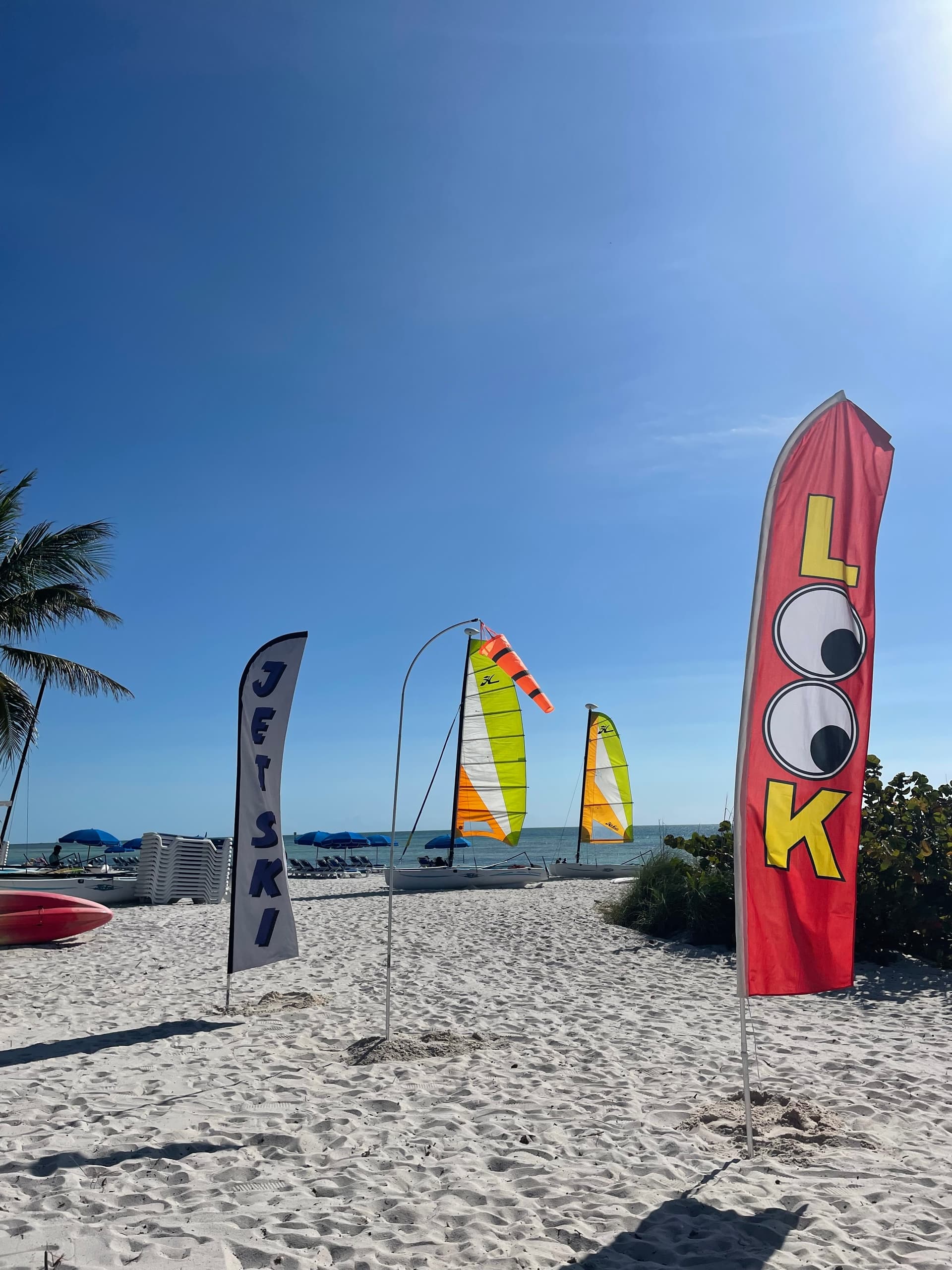 Sailboat lessons on sandy Key West beach with colorful sails