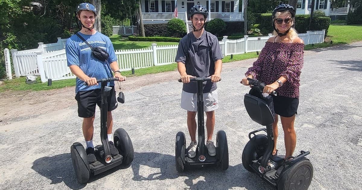 Group of three on Segways touring historic Charleston streets