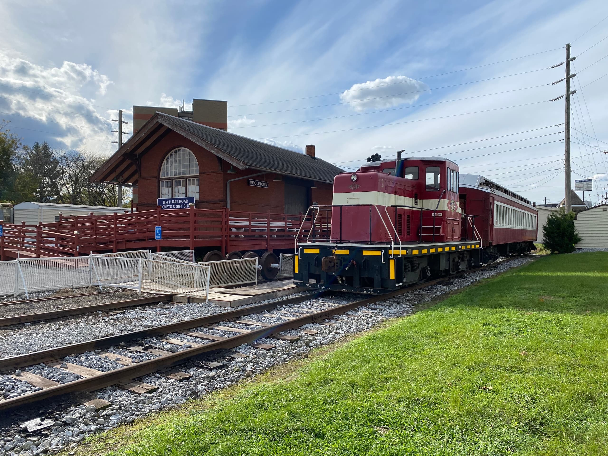 Heritage train departing station along rural tracks