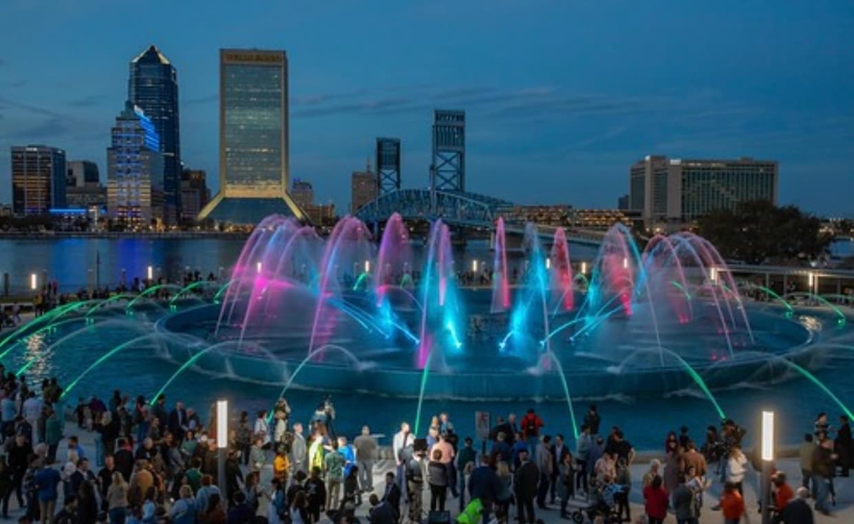 Evening fountain show with crowd and Jacksonville riverfront skyline