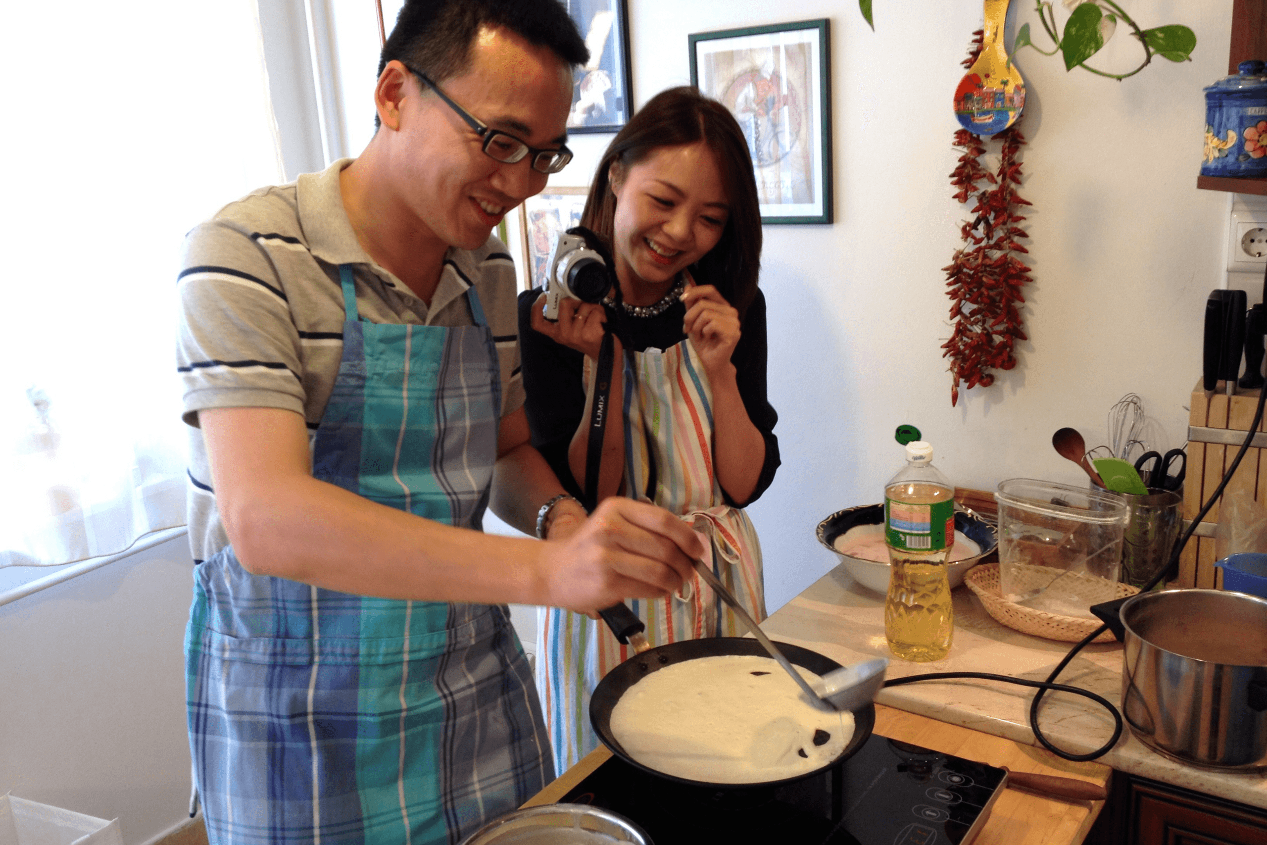 Couple cooking traditional Hungarian pancake in Budapest kitchen class