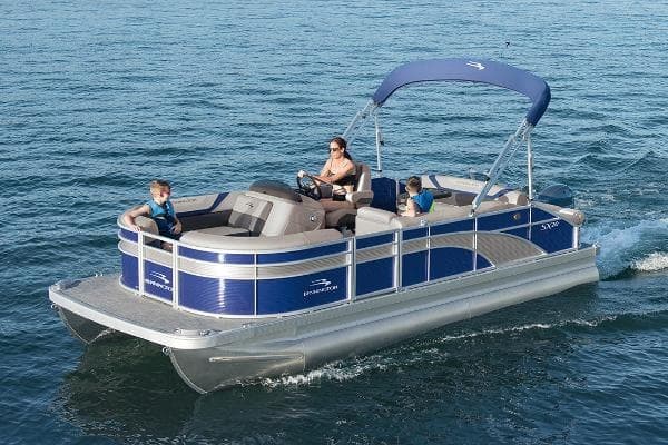 Pontoon boat cruising on open blue lake with family relaxing aboard