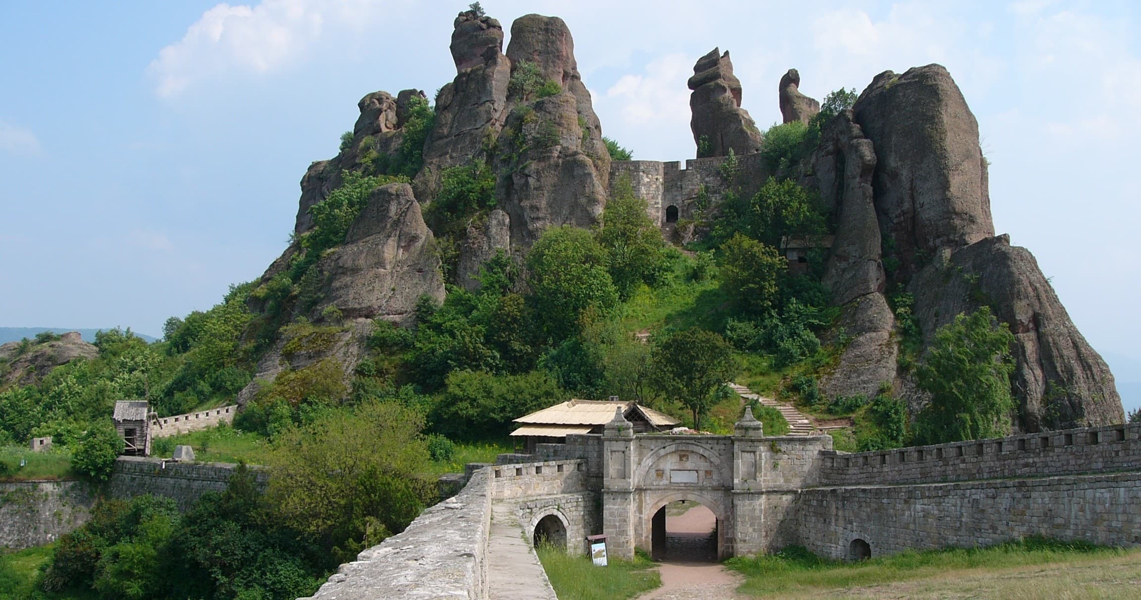 Dramatic rock fortress with towering sandstone formations, hiking