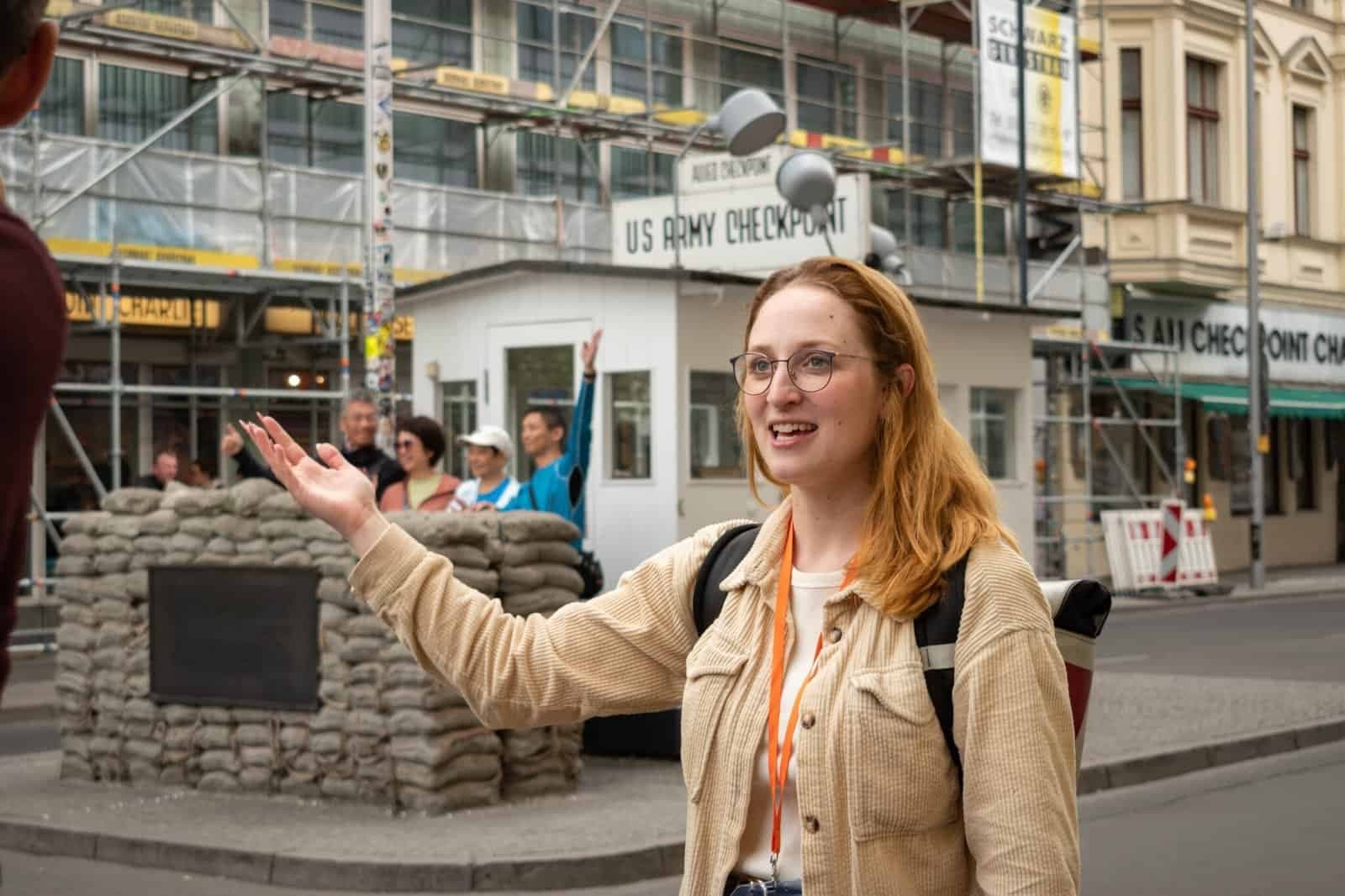 Tour guide presenting Cold War checkpoint site on Berlin walking tour