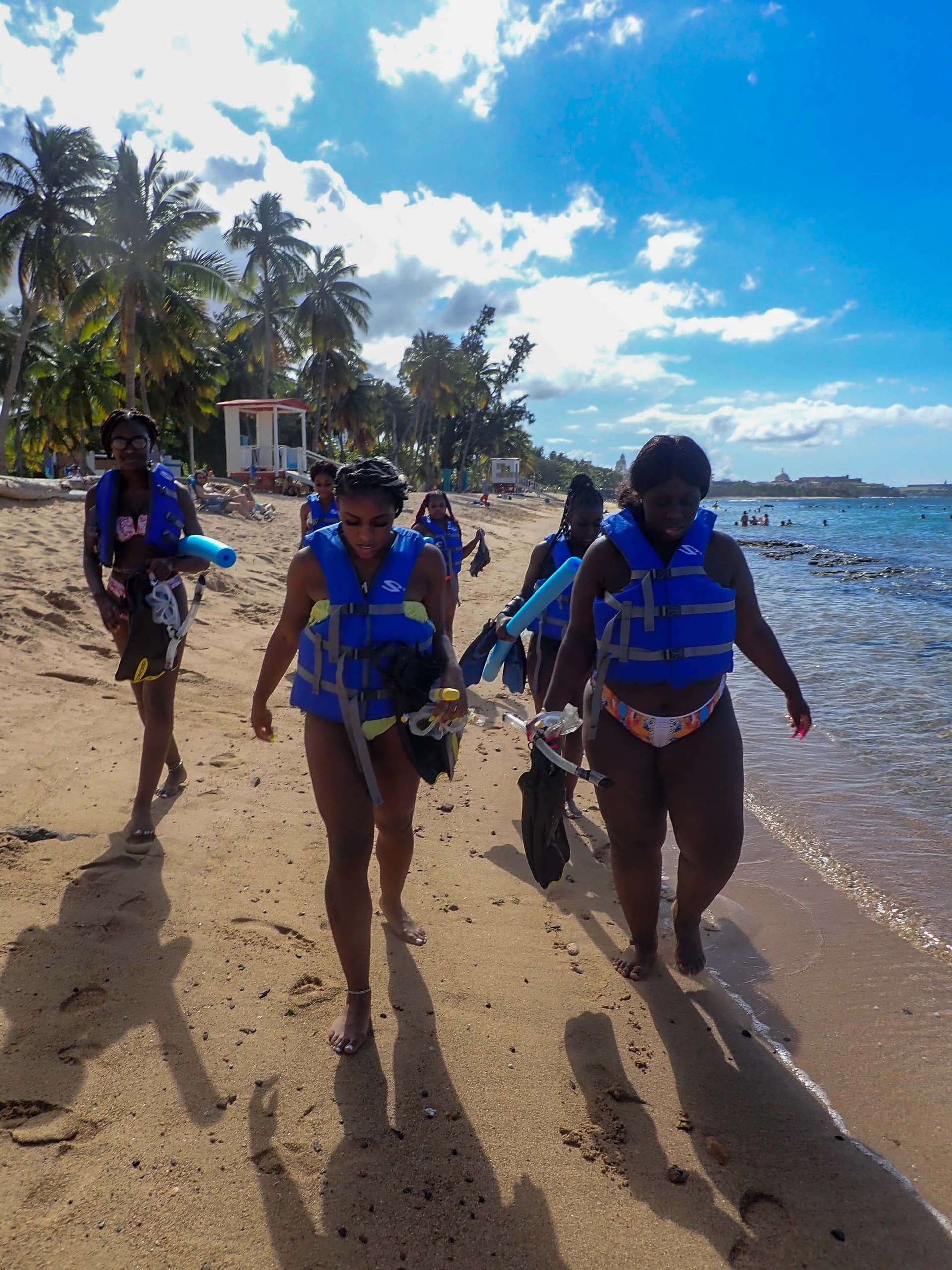 Snorkeling tour group forming line in vibrant shallow water