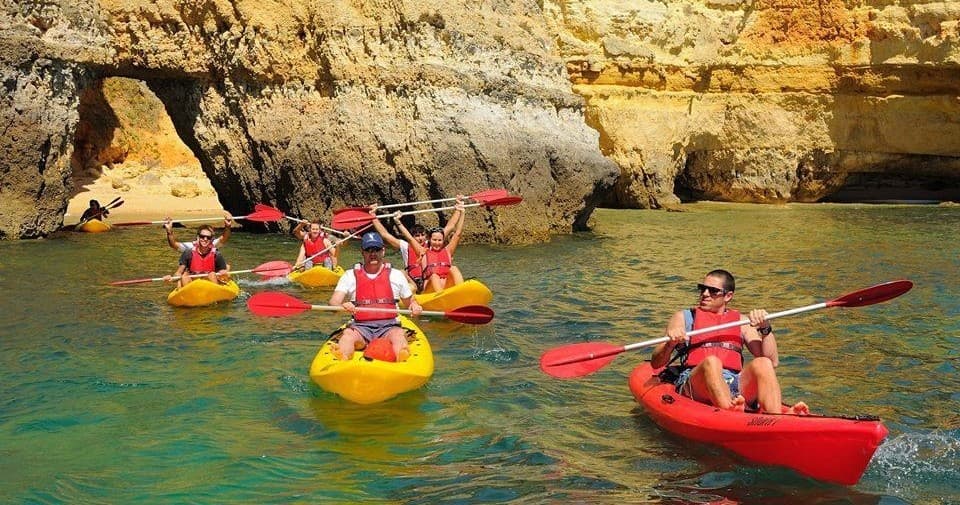 Paddlers navigating coastal caves and cliffs on Lagos sea tour