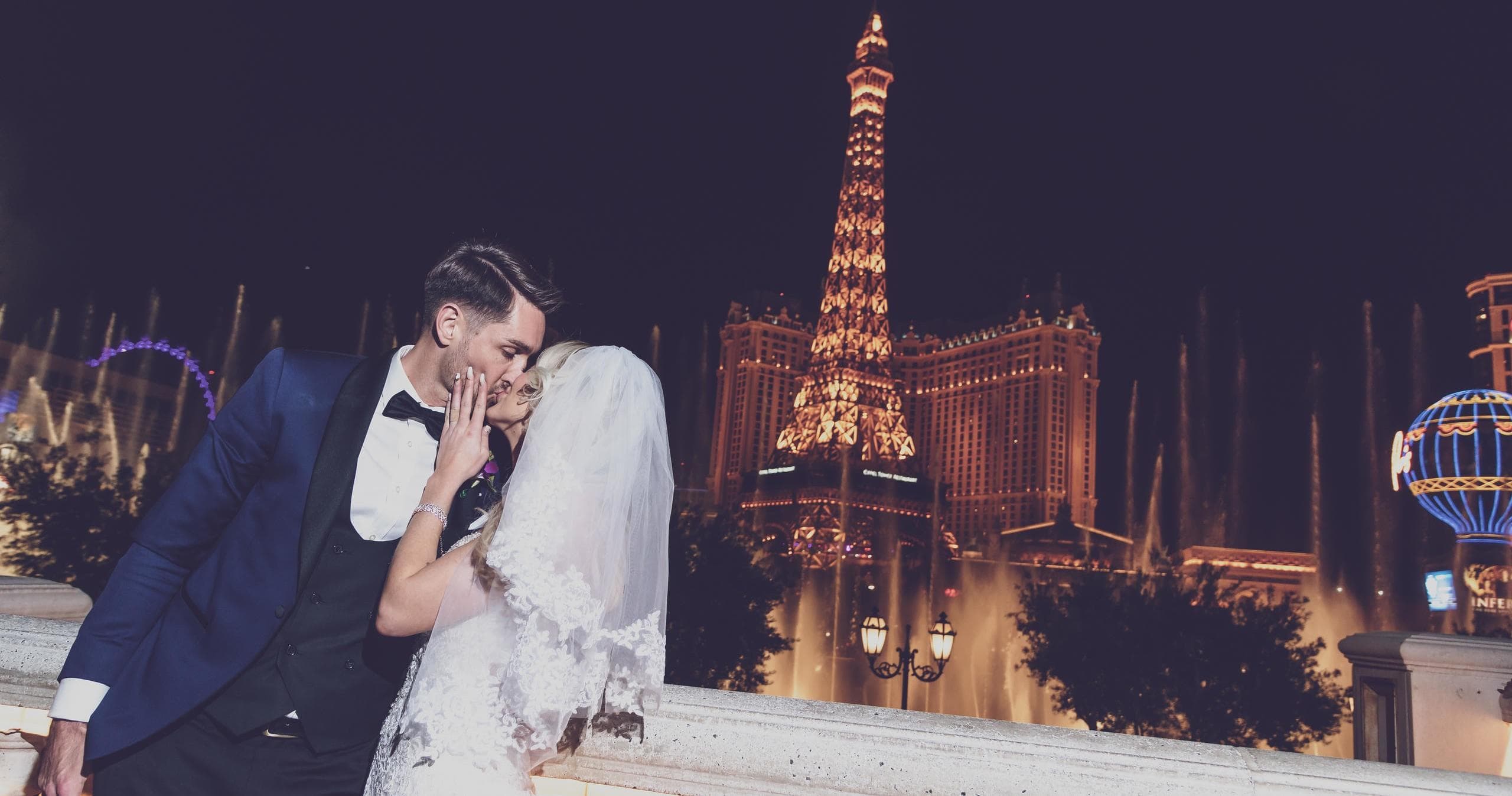Couple kissing by Paris-Eiffel tower replica on Las Vegas Strip