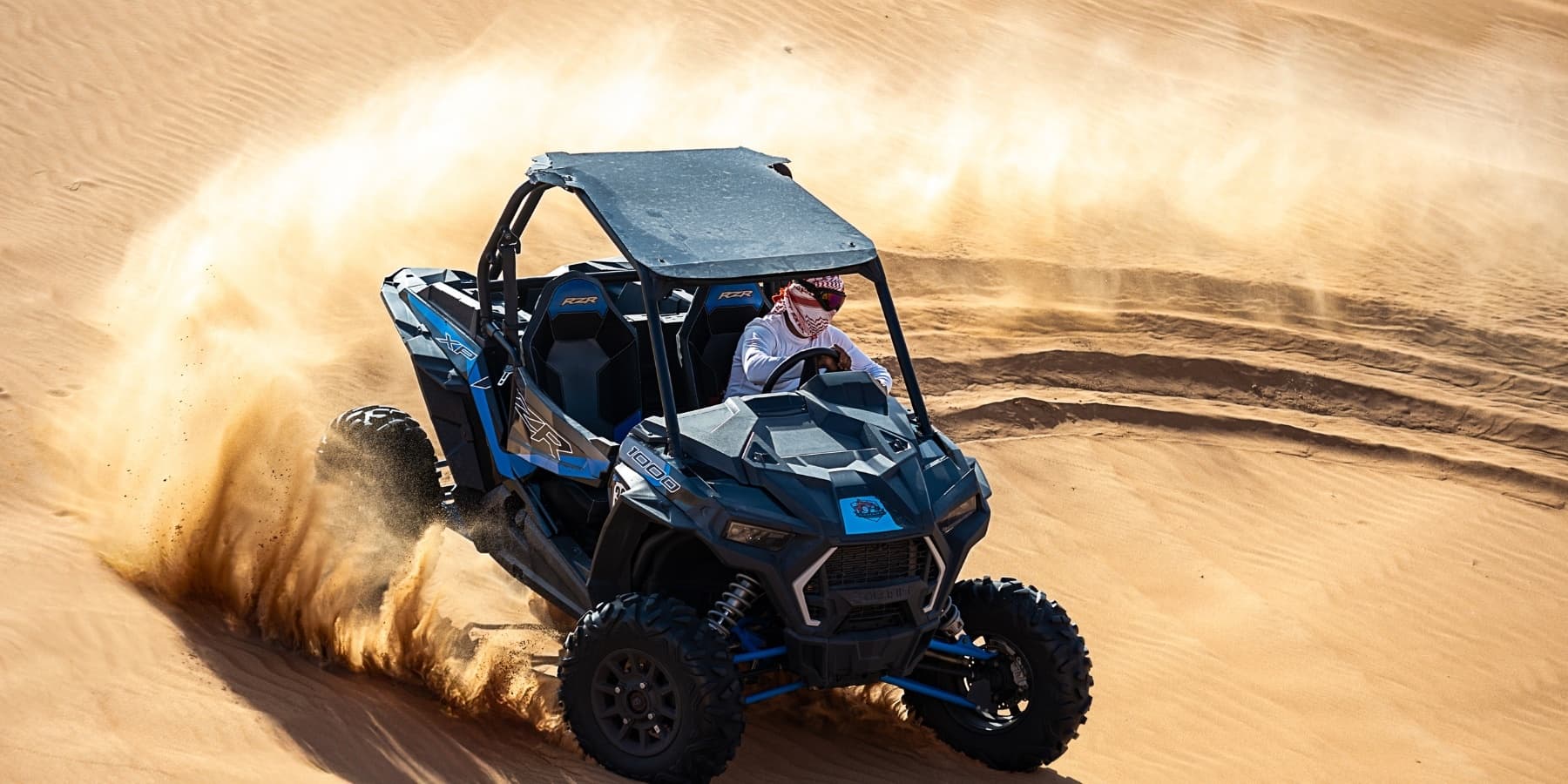 Off-road dune buggy carving sand spray in desert adventure