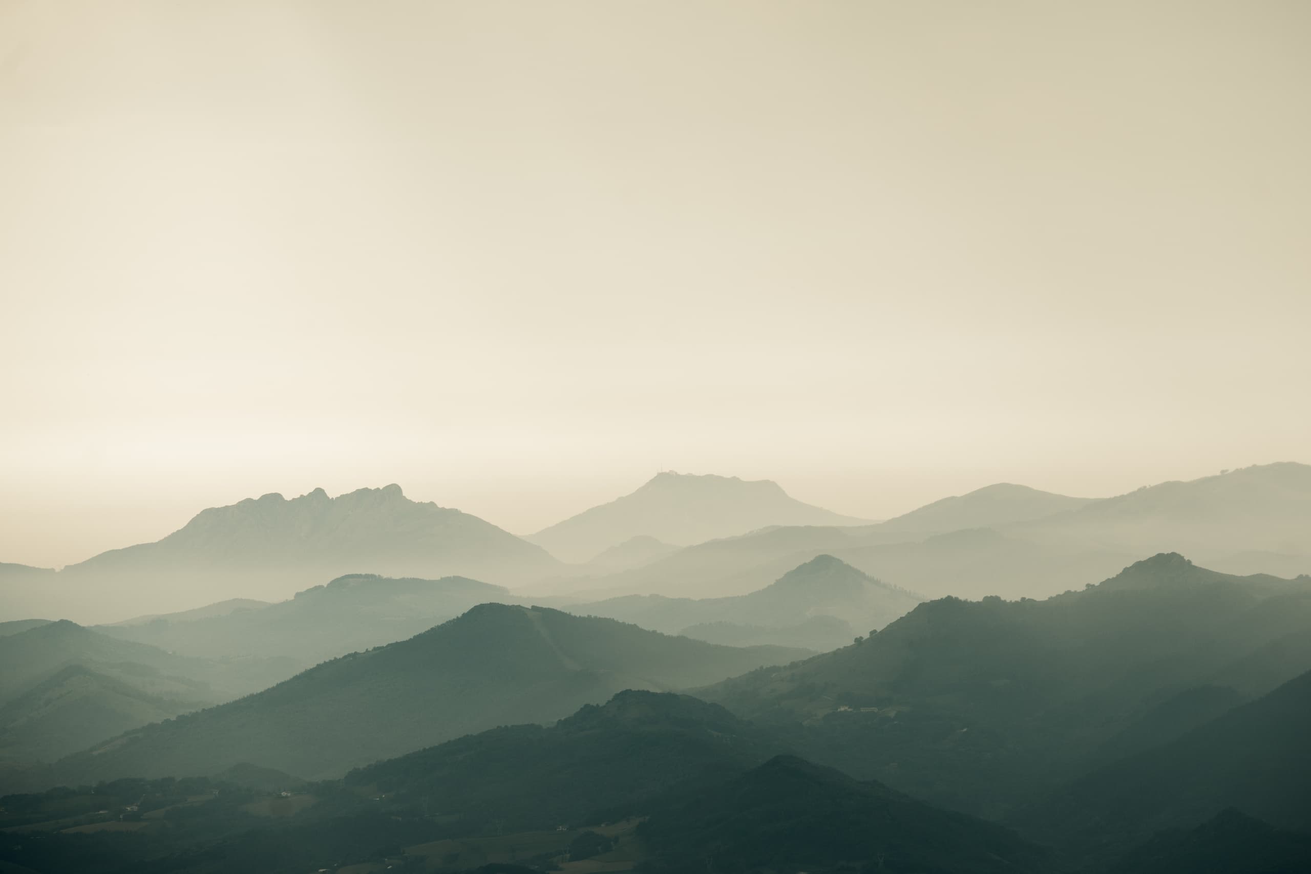 Misty mountain ridgelines at sunrise, scenic hiking vista