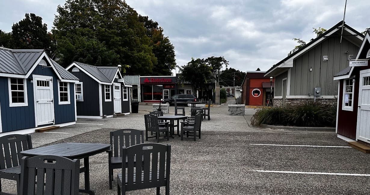 Coastal village cottages and outdoor seating in cloudy seaside plaza