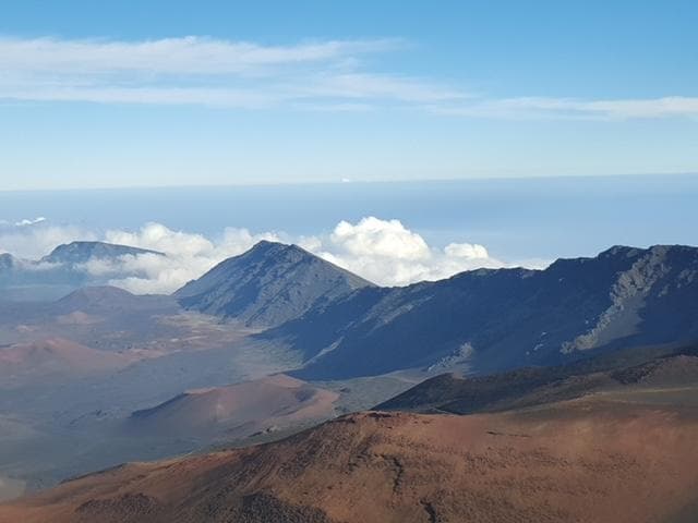 Panoramic volcanic crater view above clouds, Haleakala summit vista