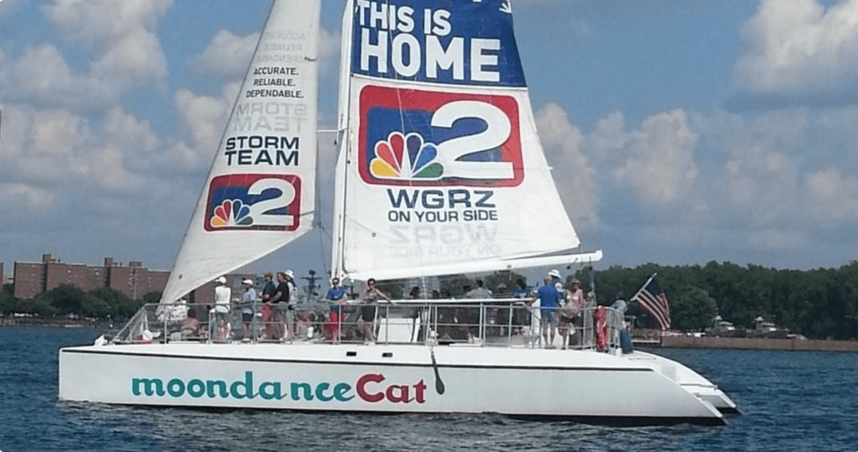 Close-up Moondance catamaran sail with WGRZ branding on Lake Erie