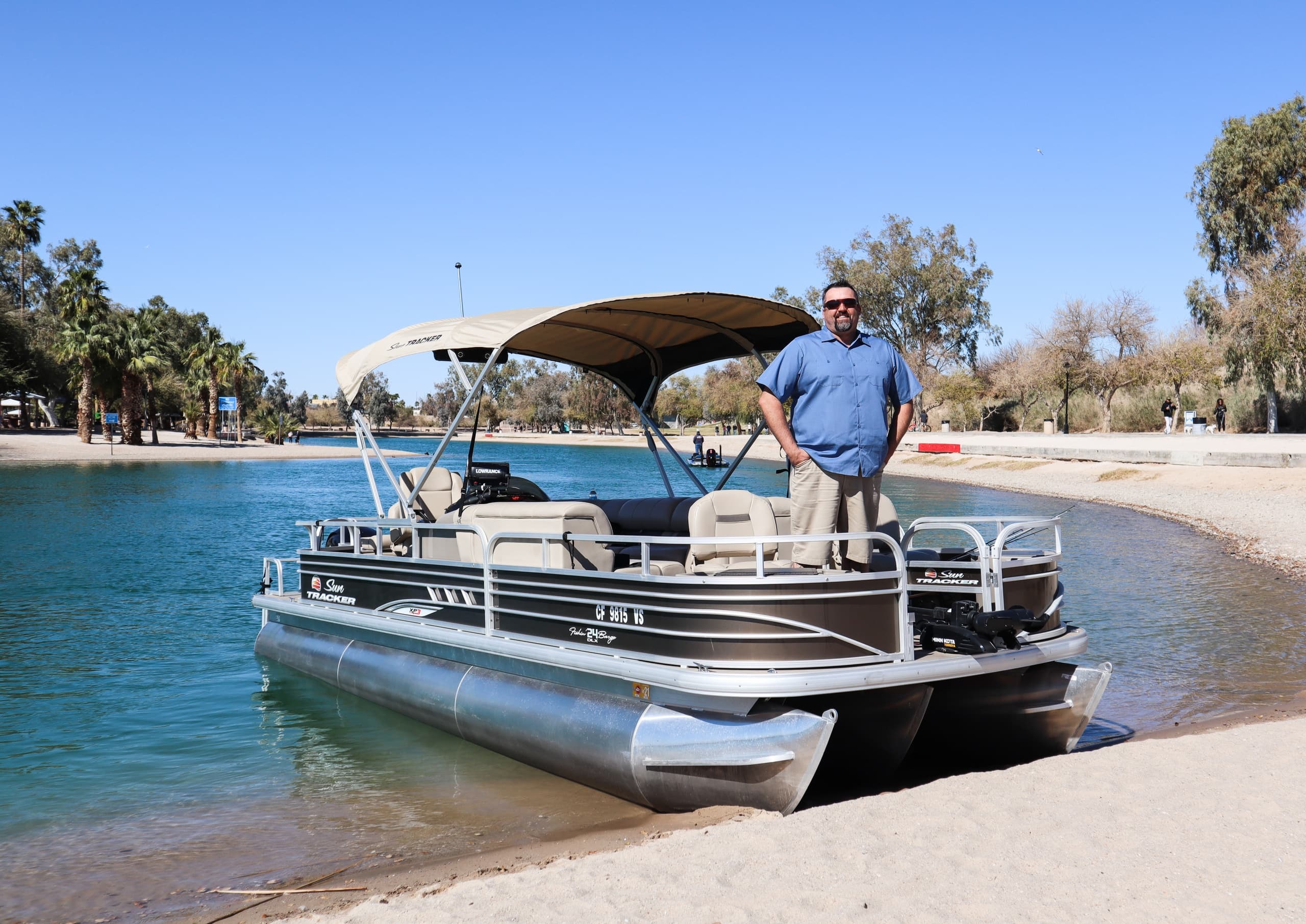 Pontoon boat beached on Lake Havasu with guide standing