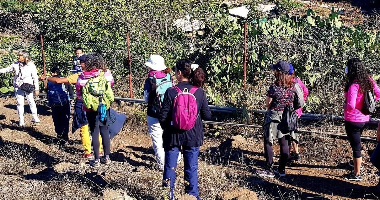 Guided group hike across dry volcanic terrain with local guide