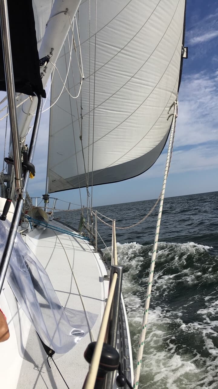 Close-up view of sail and rigging while sailing in choppy sea